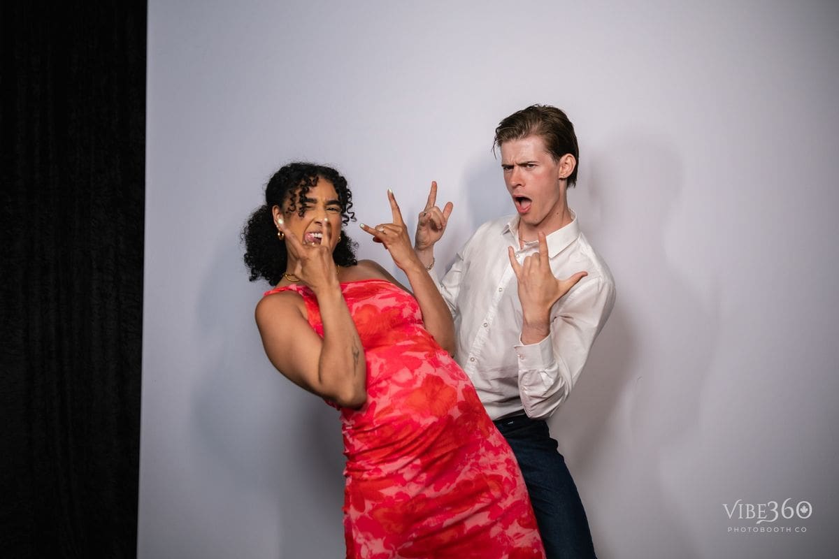 Party guests laughing inside a photo booth in Ottawa