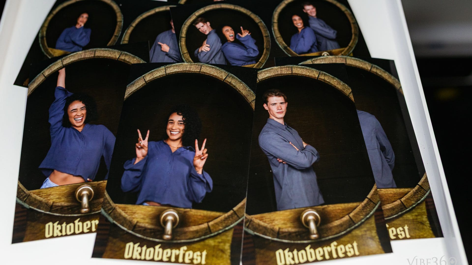 Group posing with fun expressions at Oktoberfest photo booth.
