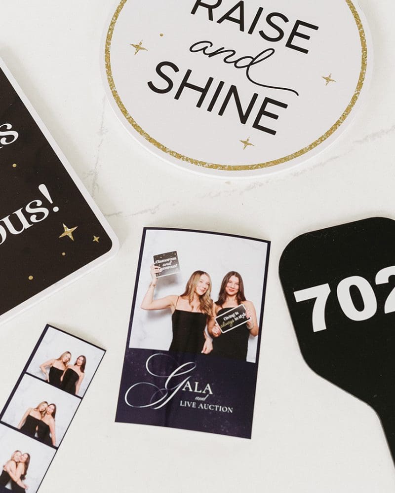Gala event photo booth items: Glamorous and Generous sign, auction paddle, and pictures from the event.